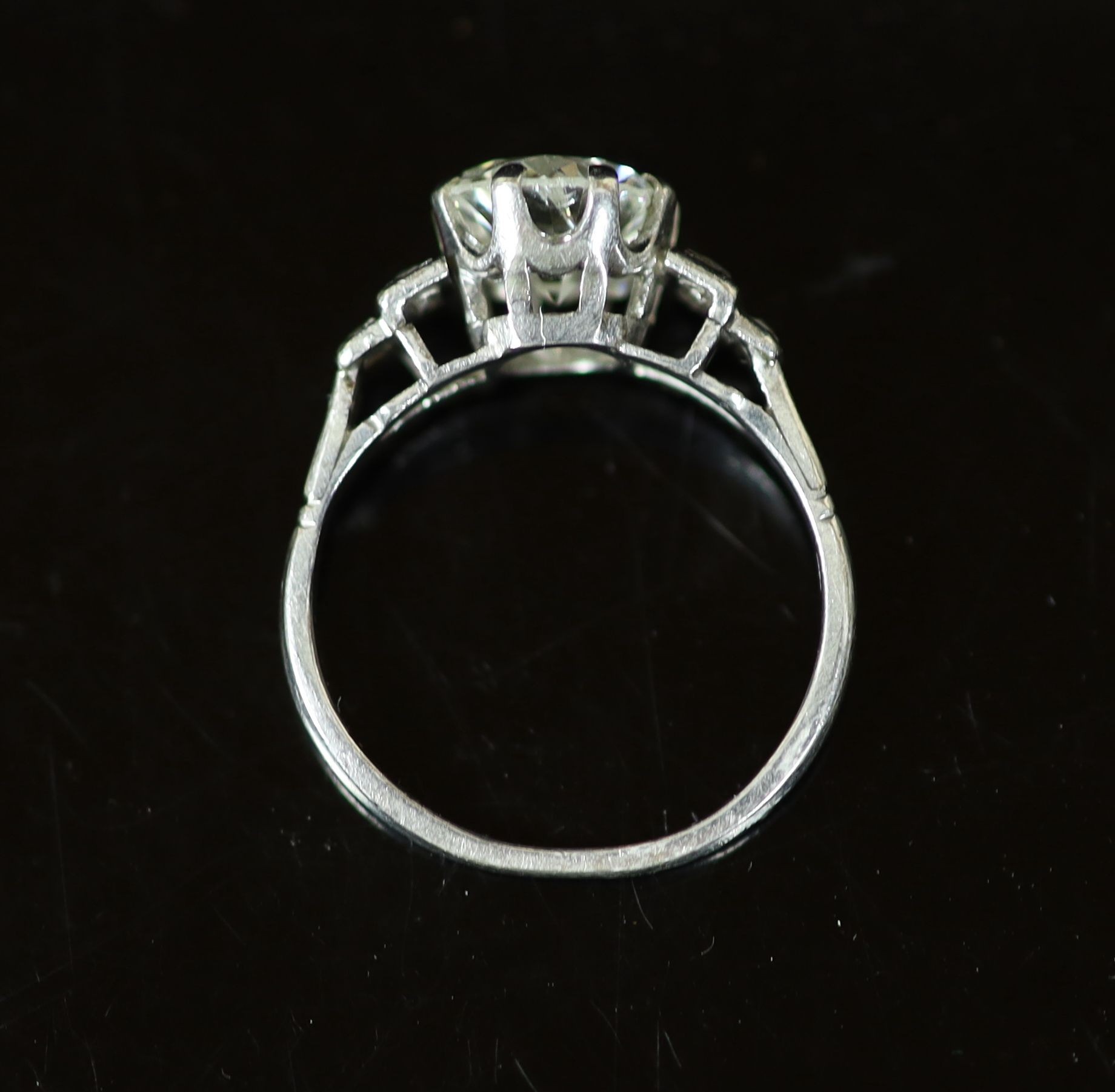 A platinum and single stone diamond ring, with six stone rose cut diamond set shoulders